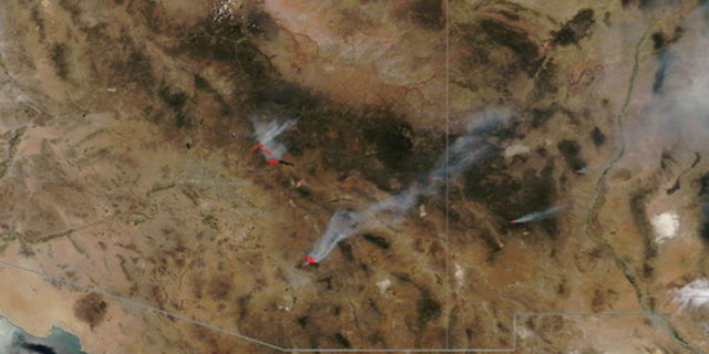 Fire and smoke from three major wildfires burning in Arizona can be seen on this NASA satellite photo from June 18, 2020.