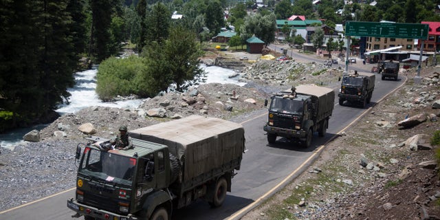 An Indian army convoy moves on the Srinagar-Ladakh highway in northeast India on Wednesday. (AP)