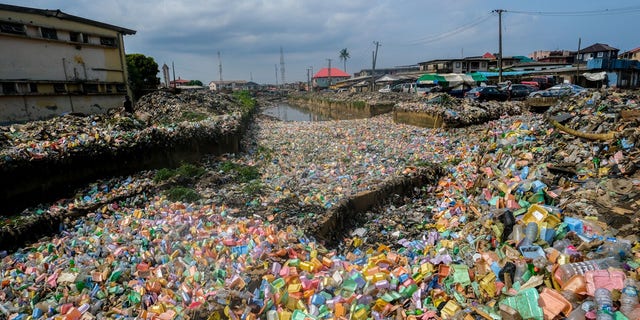 Garbage piles cover fields after heavy rainfall in Lagos, Nigeria on June 7.