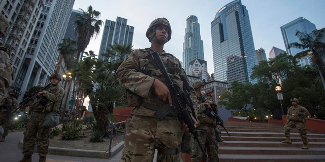Members of California National Guard stand guard in Pershing Square, Sunday, May 31, 2020, in Los Angeles.