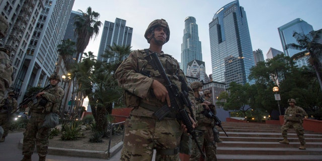 Members of California National Guard stand guard in Pershing Square, Sunday, May 31, 2020, in Los Angeles.