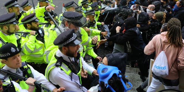 Police clash with protesters during a Black Lives Matter protest rally in Westminster, London, on Sunday. (AP/PA)