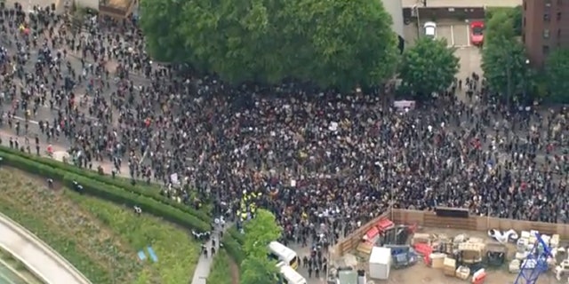 An aerial grab taken from video of protesters demonstrating outside the US embassy in London on Sunday. (AP/UK Pool)