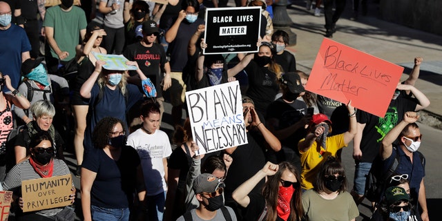 Protesters march Monday, June 1, 2020, in Louisville, Ky., over the deaths of George Floyd and Breonna Taylor. Taylor, a black woman, was fatally shot by police in her home in March.