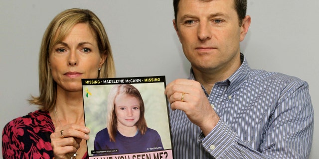 In this May 2, 2012, file photo, Kate and Gerry McCann pose for the media with a missing poster depicting an age progression computer generated image of their daughter Madeleine at nine years of age.