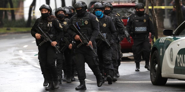 Police officers arrive at the area where a shooting took place in Mexico City, Mexico, June 26, 2020. (REUTERS/Henry Romero)