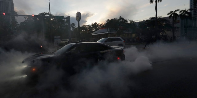 A protester does a burnout as he and others demonstrate over the death of George Floyd, Sunday, May 31, 2020, in Miami.