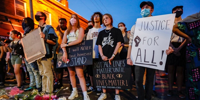 Protesters gather at a memorial for George Floyd where he died outside Cup Foods on East 38th Street and Chicago Avenue, Monday, June 1, 2020, in Minneapolis. Protests continued following the death of George Floyd, who died after being restrained by Minneapolis police officers on May 25. (AP Photo/John Minchillo)