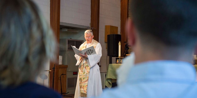 VIRGINIA BEACH, Va. (June 17, 2020) Cmdr. John Connolly, a chaplain assigned to the aircraft carrier USS George H. W. Bush (CVN 77), from Charlotte, North Carolina, delivers a sermon to Sailors and civilians gathered for a baptism in the ship's bell. (U.S. Navy photo by Mass Communication Specialist 3rd Class Steven Edgar)
