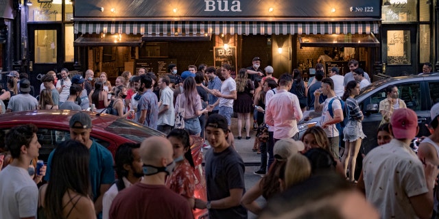 People drink outside a bar during the reopening phase following the coronavirus disease (COVID-19) outbreak in the East Village neighborhood in New York City, U.S., June 12, 2020. Picture taken June 12, 2020. REUTERS/Jeenah Moon