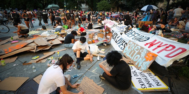 A group of Black Lives Matter protestors prepare banners at City Hall across from One Police Plaza as part of the 