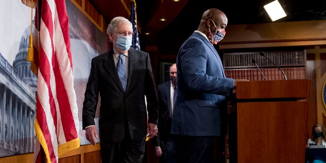 Senate Majority Leader Mitch McConnell of Ky., left, and Sen. Tim Scott, R-S.C., right, arrive at a news conference to announce a Republican police reform bill on Capitol Hill, Wednesday, June 17, 2020, in Washington. (AP Photo/Andrew Harnik)