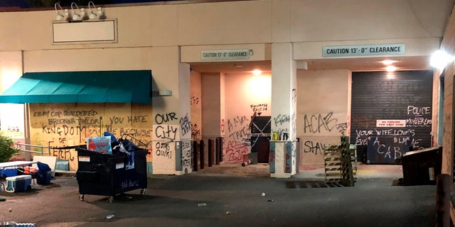 This Friday, June 26, 2020, photo released by the Portland Police Department shows damage after protests calling for an end to racial injustice and accountability for police in Portland, Ore. Some protesters set fire to a police precinct, vandalized businesses and tried to barricade police officers inside their station during a demonstration early Friday morning that ended with law enforcement using tear gas to disperse the crowd, authorities said. (Portland Police Department via AP)