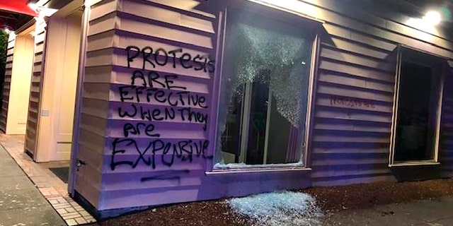 This Friday, June 26, 2020, photo released by the Portland Police Department shows damage after protests calling for an end to racial injustice and accountability for police in Portland, Ore. Some protesters set fire to a police precinct, vandalized businesses and tried to barricade police officers inside their station during a demonstration early Friday morning that ended with law enforcement using tear gas to disperse the crowd, authorities said. (Portland Police Department via AP)