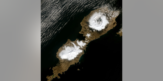 Alaska’s Umnak Island in the Aleutians showing the huge, 10-km wide caldera (upper right) largely created by the 43 BCE Okmok II eruption at the dawn of the Roman Empire. Landsat-8 Operational Land Imager image from May 3, 2014. Credit: U.S. Geological Survey.
