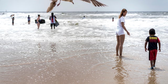 With social distancing guidelines enforced, crowds gathered on Mission Beach on Memorial Day weekend during the COVID-19 pandemic in San Diego, California. (Photo by Melina Mara/The Washington Post via Getty Images)