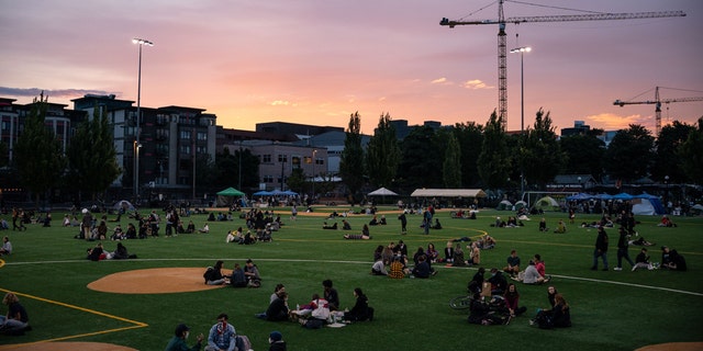 People sit in Cal Anderson Park in the so-called "Capitol Hill Autonomous Zone" on June 10, 2020 in Seattle, Wash. (Photo by David Ryder/Getty Images)