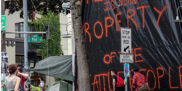 The seemingly abandoned East Precinct station of the Seattle Police Department is covered in a tarp declaring it 'property of the Seattle people'. Protesters declared a Cop Free Zone following days of demonstrations in response to the police-involved death of George Floyd in Minneapolis.