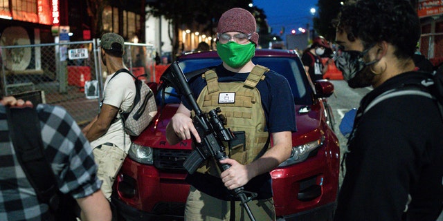 A volunteer works security at an entrance to the so-called 