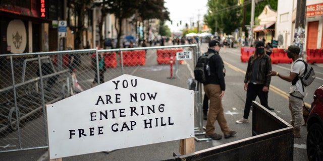 A sign is seen on a barrier at an entrance to the so-called "Capitol Hill Autonomous Zone" on June 10, 2020 in Seattle, Washington.