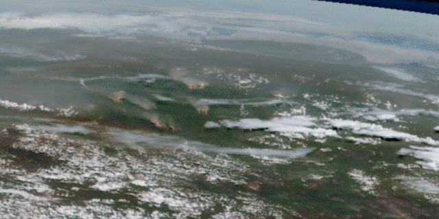 Smoke and flames from active fires burning across Sibera can be seen on this satellite imagery from June 21.