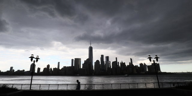 A rainstorm passes over lower Manhattan and One World Trade Center in New York City on May 11, 2020, as seen from Jersey City, New Jersey.