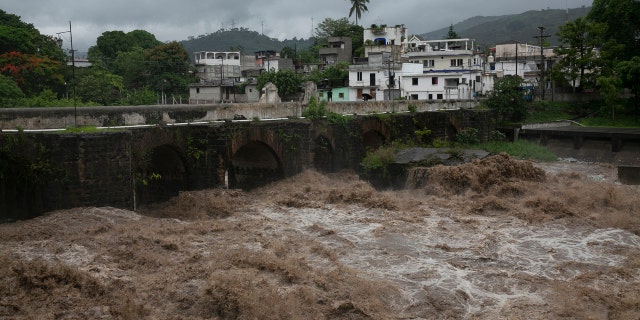 The swollen Los Esclavos River flows violently during tropical storm Amanda in Cuilapa, eastern Guatemala, Sunday, May 31, 2020.