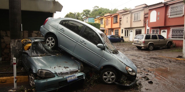 Vehicles stand damaged by an Acelhuate River flash flood at a neighborhood in San Salvador, El Salvador, May 31.
