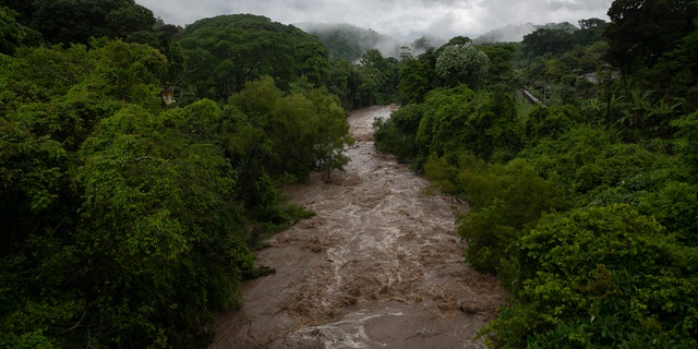 The swollen Los Esclavos River flows violently during tropical storm Amanda in Cuilapa, eastern Guatemala, Sunday, May 31, 2020.
