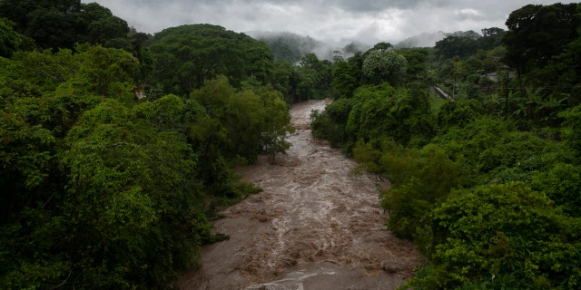 The swollen Los Esclavos River flows violently during tropical storm Amanda in Cuilapa, eastern Guatemala, Sunday, May 31, 2020.