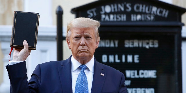 President Donald Trump holds a Bible as he visits outside St. John's Church across Lafayette Park from the White House.