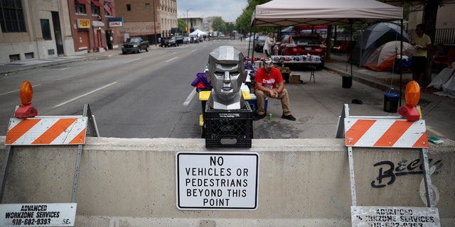 June 19: A metal bust of President Trump is on display outside the BOK Center as people line up to attend his campaign rally in Tulsa, Oklahoma. (Photo by Win McNamee/Getty Images)