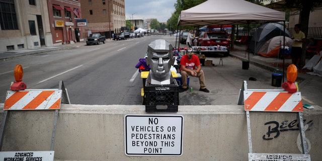 June 19: A metal bust of President Trump is on display outside the BOK Center as people line up to attend his campaign rally in Tulsa, Oklahoma. (Photo by Win McNamee/Getty Images)