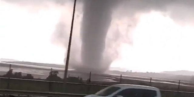 A large waterspout was seen moving across Istanbul’s Lake Buyukcekmece on Tuesday as torrential rain hit the city.