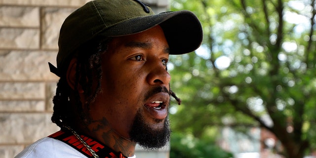 Daylan McLee stands on the porch of his home in Uniontown, Pa., Monday, June 22, 2020. On Sunday McLee helped pull Uniontown Police Officer Jay Hanley from his burning patrol car following a collision. (AP Photo/Gene J. Puskar)