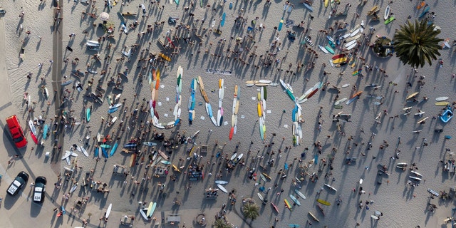 Hundreds of surfers gather in support of Black Lives Matter, following the death in Minneapolis police custody of George Floyd, as they spell "UNITY" with their boards before participating in a paddle out for unity at Moonlight Beach in Encinitas, Calif., June 3. Tyler Transki/Handout via REUTERS  