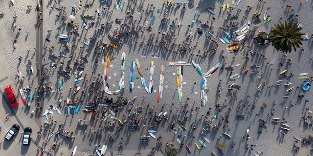 Hundreds of surfers gather in support of Black Lives Matter, following the death in Minneapolis police custody of George Floyd, as they spell "UNITY" with their boards before participating in a paddle out for unity at Moonlight Beach in Encinitas, Calif., June 3. Tyler Transki/Handout via REUTERS