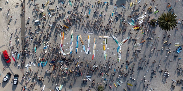 Hundreds of surfers gather in support of Black Lives Matter, following the death in Minneapolis police custody of George Floyd, as they spell "UNITY" with their boards before participating in a paddle out for unity at Moonlight Beach in Encinitas, Calif., June 3. Tyler Transki/Handout via REUTERS  