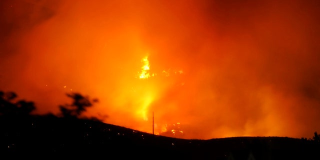The Traverse Fire burns near homes in Lehi, Utah, Sunday, June 28, 2020.
