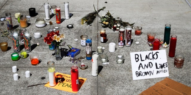 Candles and signs left at the entrance to closed Vallejo city hall seen on Wednesday, June 3, 2020, in Vallejo, Calif. (AP Photo/Ben Margot)