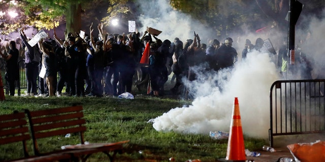 Tear gas billows as demonstrators gather in Lafayette Park to protest the death of George Floyd, Sunday, May 31, 2020, near the White House in Washington. (AP Photo/Alex Brandon)