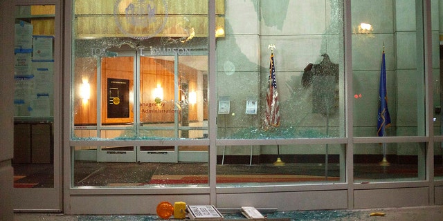 The windows of the Tommy G. Thompson Center on Public Leadership in Madison are shattered during demonstrations Tuesday. Evers said the damage to state property is still being assessed. (Emily Hamer/Wisconsin State Journal via AP)