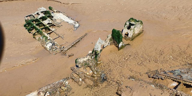 Ghostly WWII fighter plane wreck emerges from shifting sands on UK ...