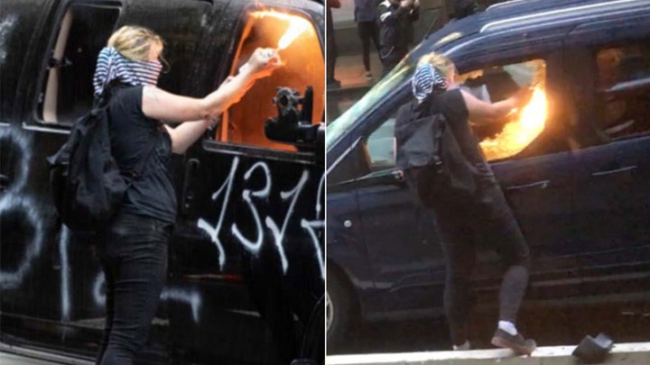 Activist charged with torching police cars in Seattle