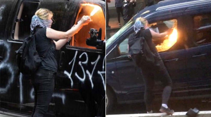 Activist charged with torching police cars in Seattle