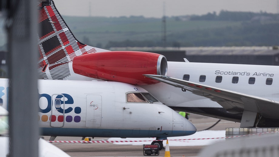 Plane ends up wedged underneath another airplane after collision at Scottish airport