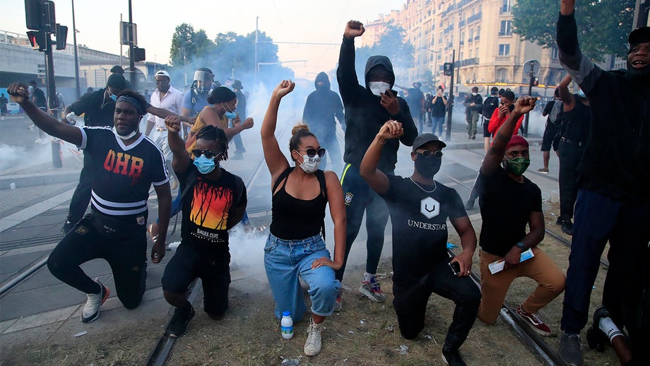 Paris police unleash tear gas as rioters spark fires, hurl debris