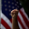 A demonstrator raises his fist during a protest over the death of George Floyd in Anaheim, Calif., June 1, 2020. 