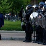 President Donald Trump walks past police in Lafayette Park after he visited St. John's Church across from the White House in Washington, D.C., June 1, 2020.