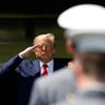 President Donald Trump salutes after speaking to over 1,110 cadets in the Class of 2020 at a commencement ceremony on the parade field, at the United States Military Academy in West Point, New York, June 13, 2020. 